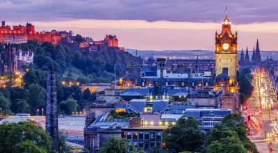 Edinburgh skyline lit up at dawn.