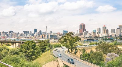 Wide angle view of Johannesburg skyline from the highways during a sightseeing tour around the urban area - Metropolitan buildings of the business district in the capital of South Africa