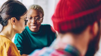 Group of multiracial male and female colleagues analysing business strategy during collaborative meeting for co research,young hipster students discussing education information while preparing to exam