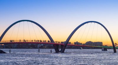 People watching the sunset from the bridge at Elizabeth Quay in Perth, the capital city of Western Australia. Panoramic image.