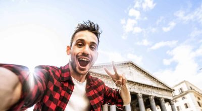 Happy tourist visiting Rome, Italy - Young man taking selfie in front of Pantheon, Italian landmark - Tourism and travel concept