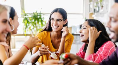 Groupe international de jeunes étudiants prenant leur petit déjeuner et mangeant ensemble dans un café - People, food and beverage concept