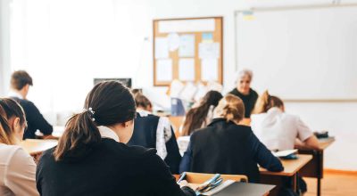 a classroom, a lecture, a lesson is going on, students are listening to the teacher, the teacher talks about the new theme of the lesson